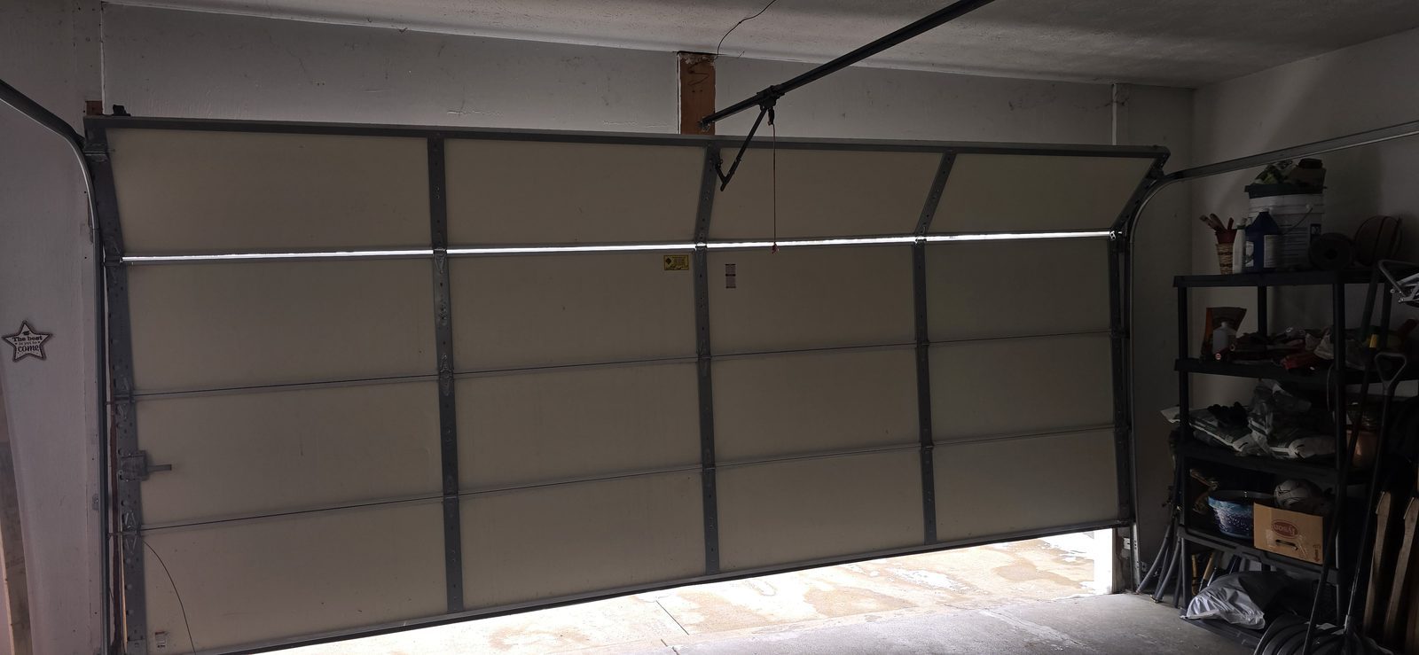 Damaged garage door before repair, photo 2