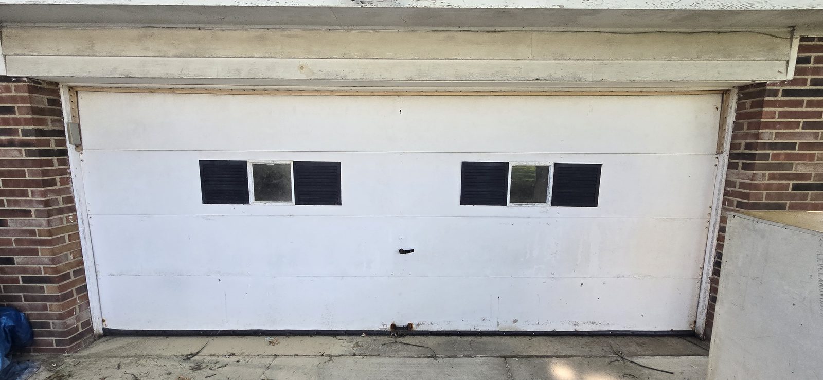 Damaged garage door before repair