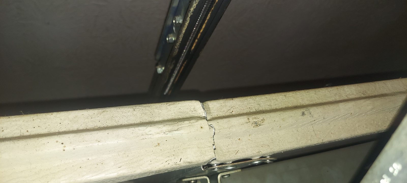 Damaged garage door before repair