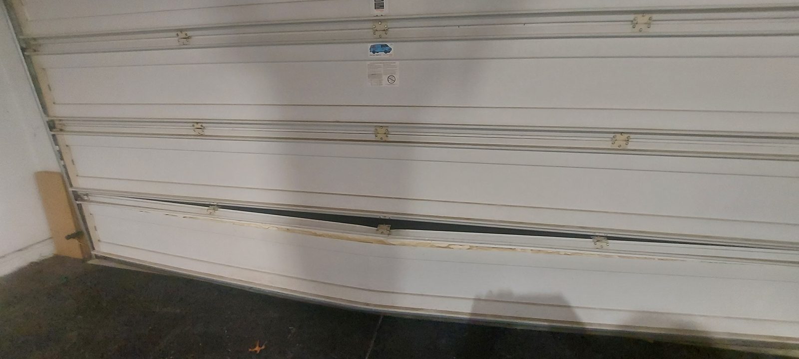 Damaged garage door before repair, photo 2