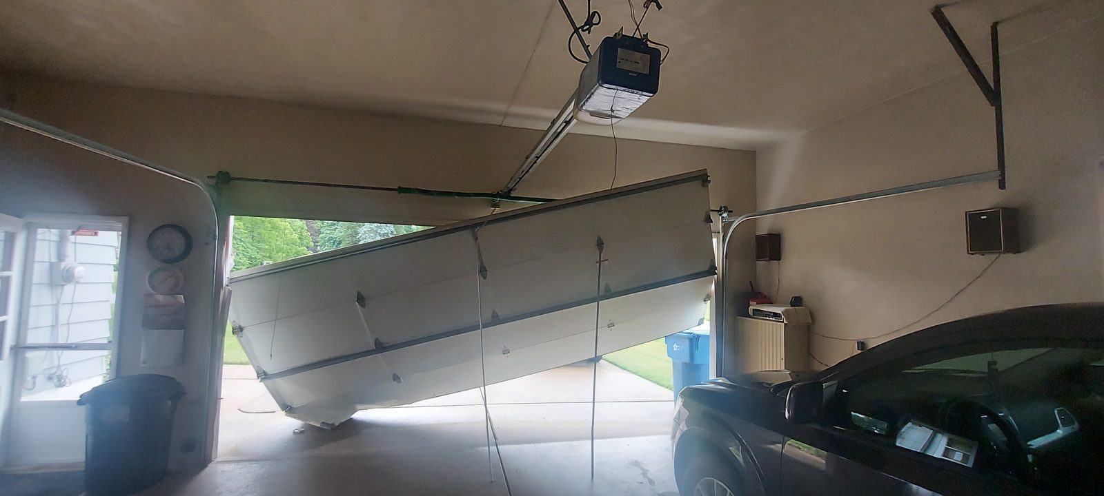 Damaged garage door before repair, photo 5