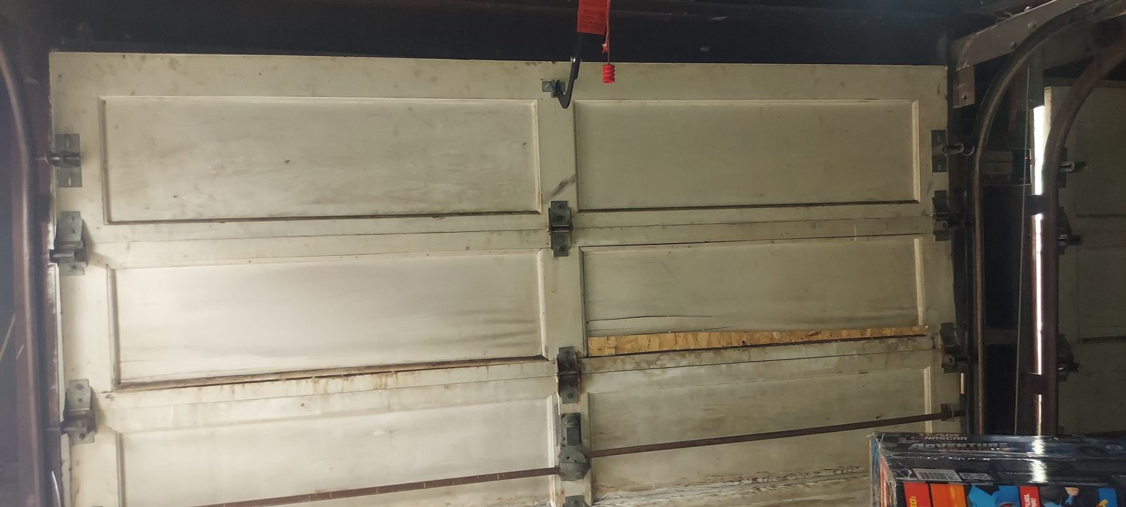 Damaged garage door before repair