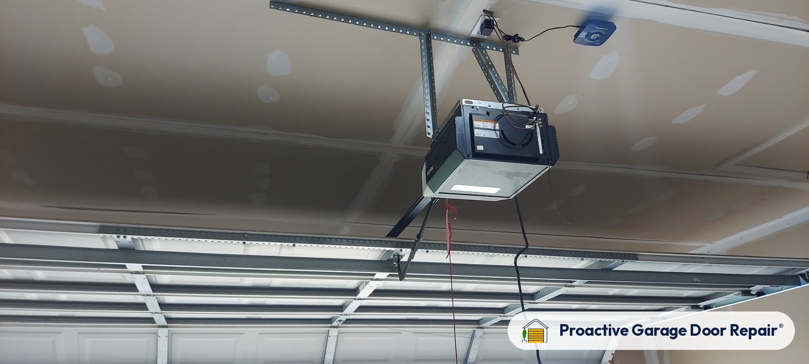 Garage door opener and rail in a customer garage, Proactive Garage Door Repair job