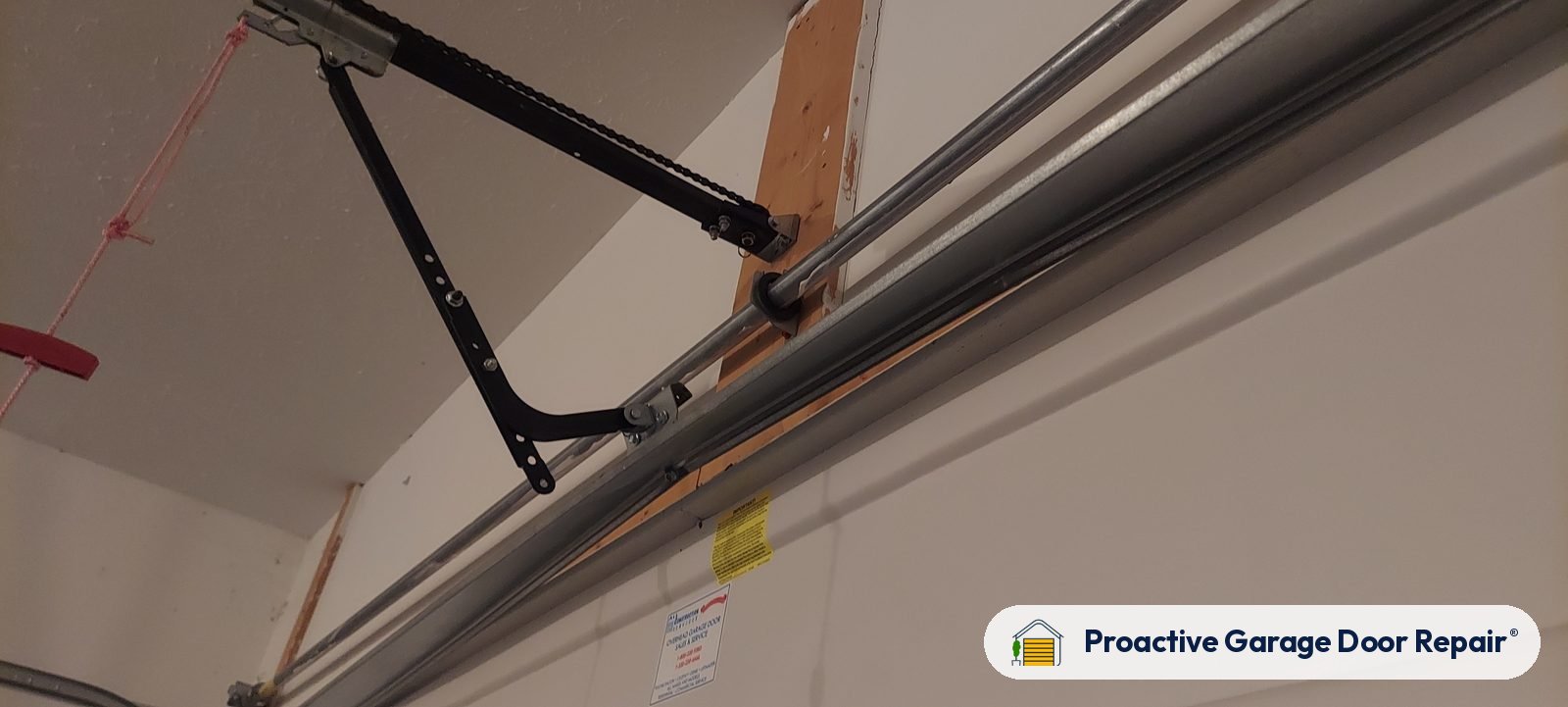 Garage door opener and rail in a customer garage, Proactive Garage Door Repair job