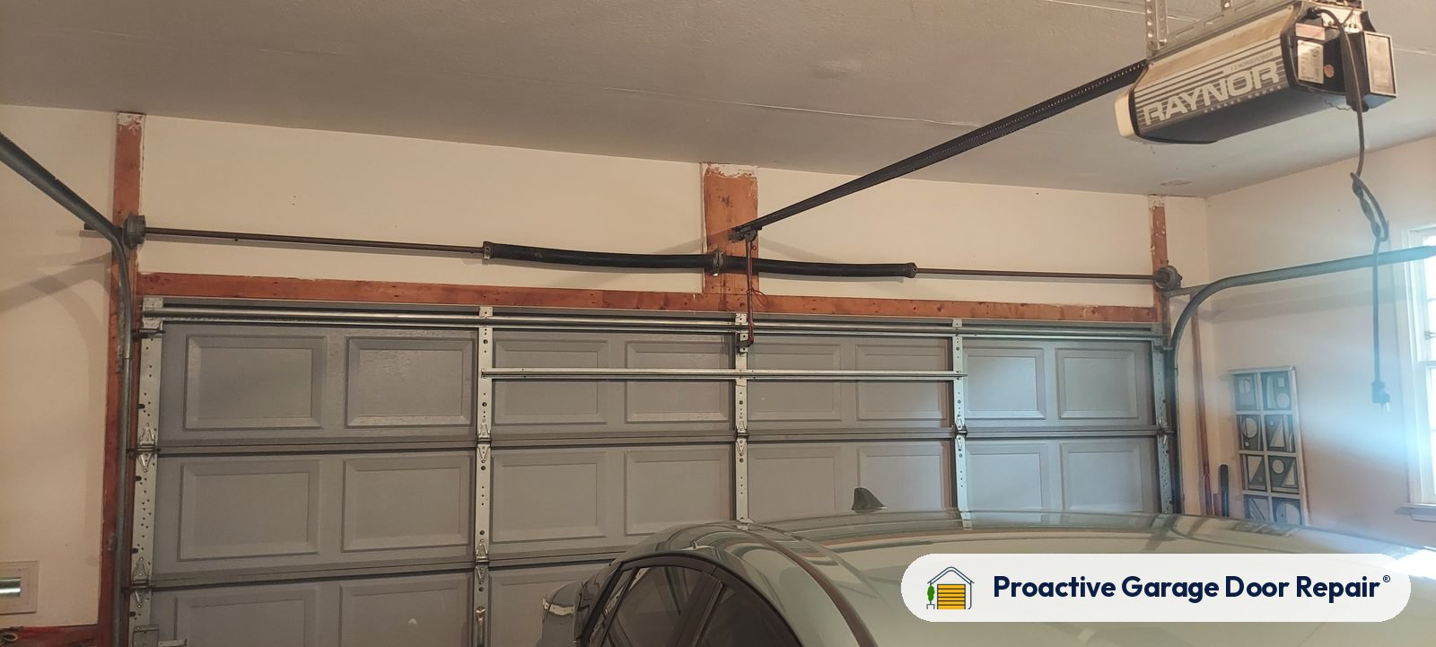 Garage door opener and rail above a double garage door